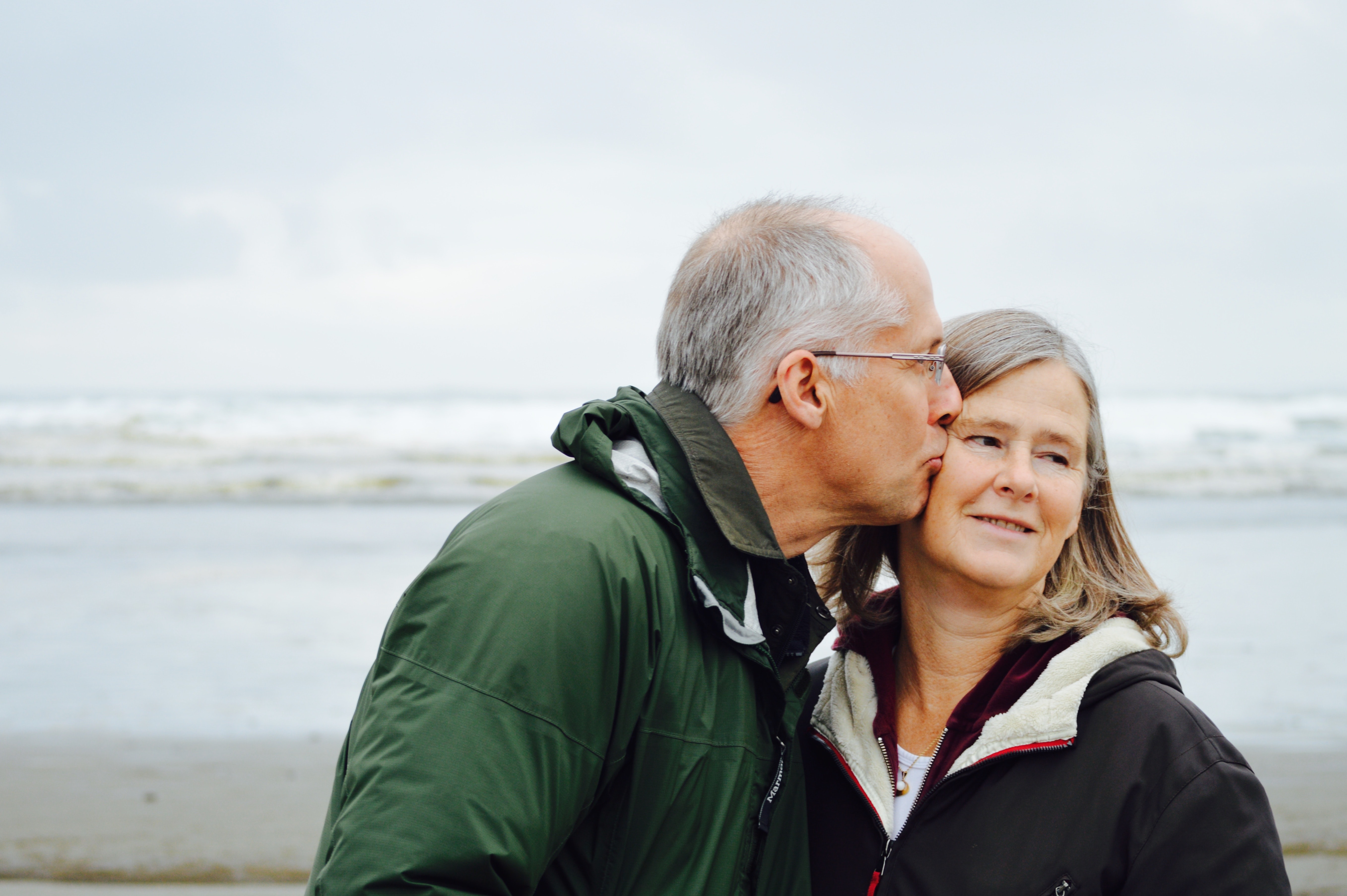 A man kissing a woman.